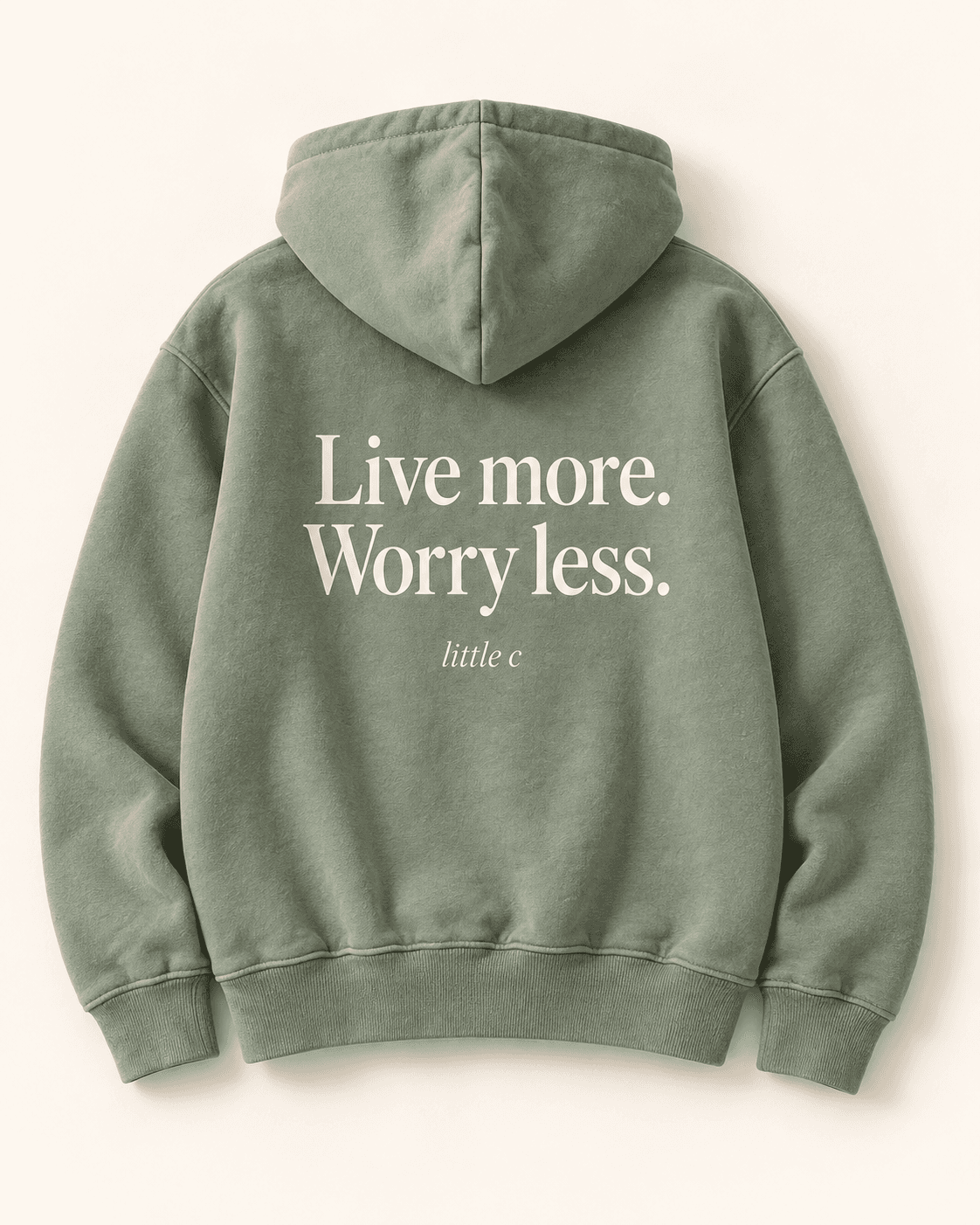 Live more hoodie — sage product mockup with “Live more. Worry less.” lettering, back view.