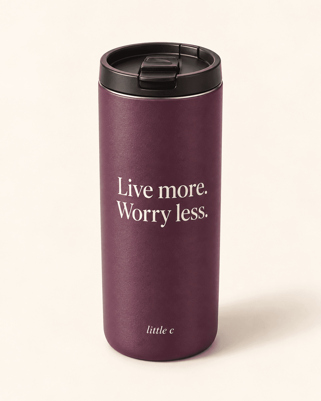 Live more travel mug — plum product mockup with “Live more. Worry less.” lettering.