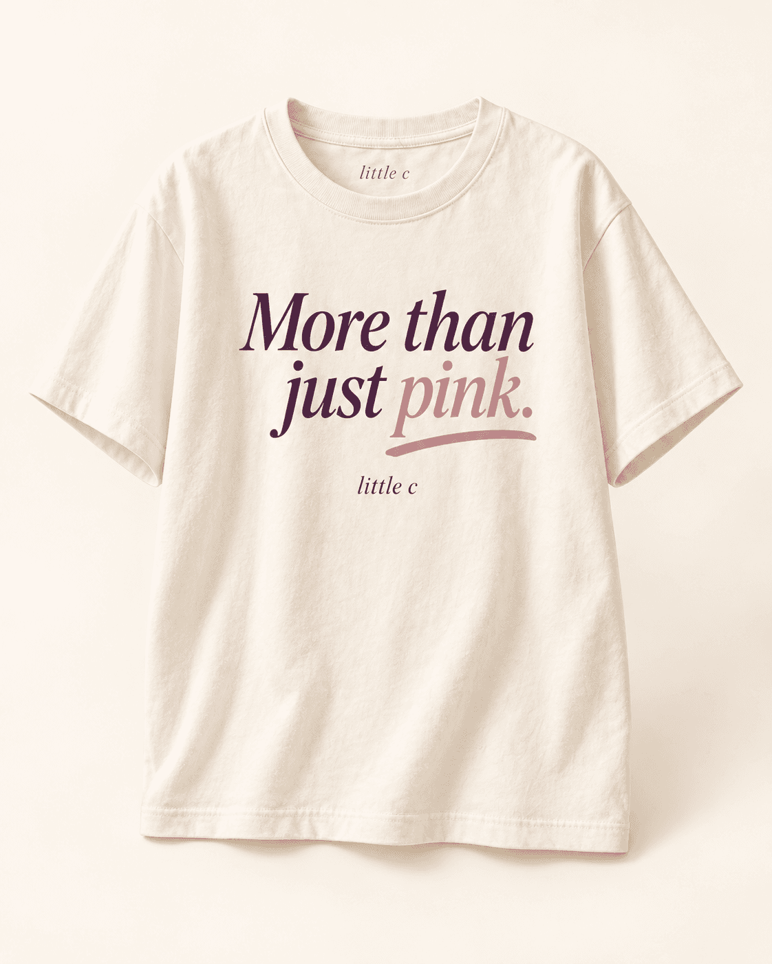 More than just pink tee — cream product mockup with “More than just pink.” lettering.